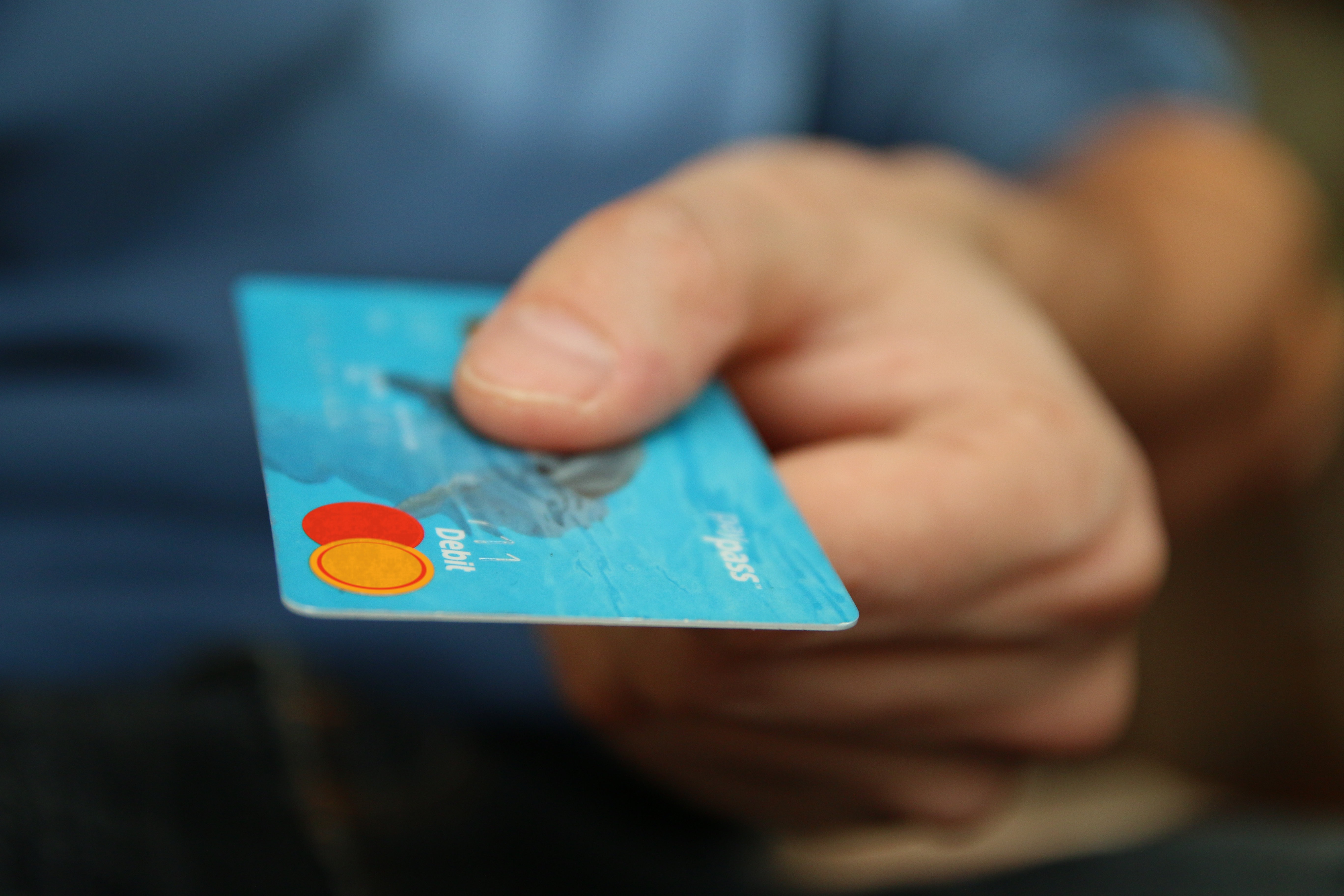 Parathon website image: Hand holding a debit card
